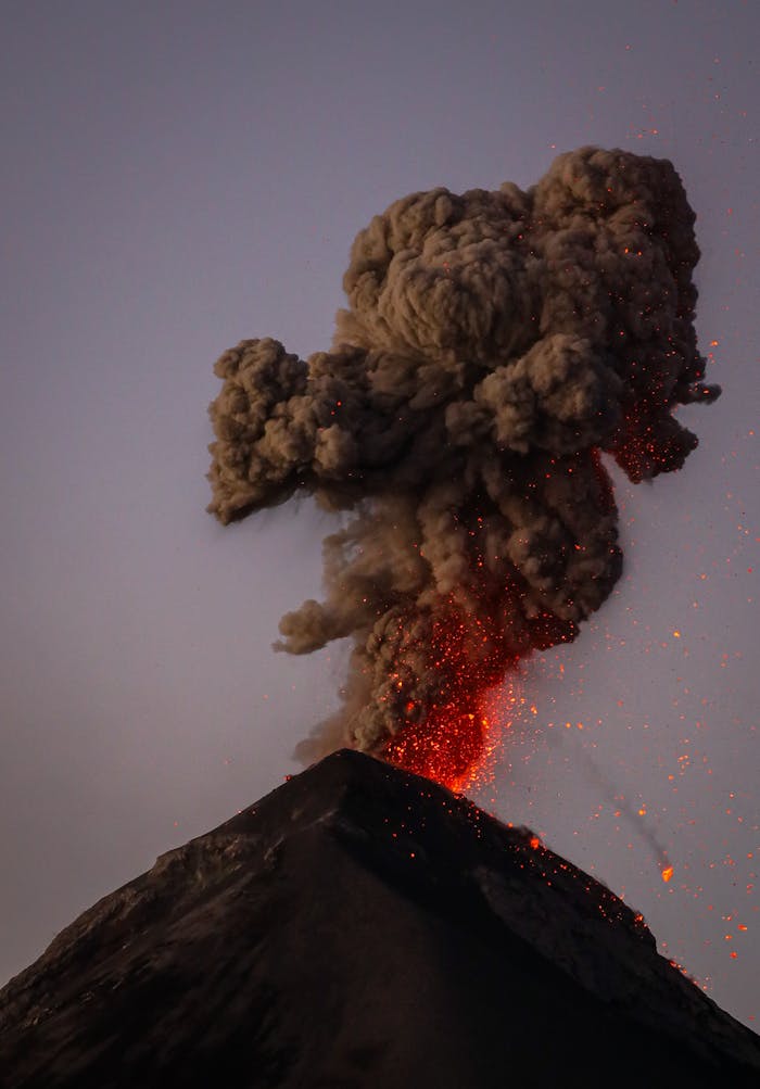 Dramatic eruption of Fuego Volcano in Guatemala, showcasing smoke and lava.